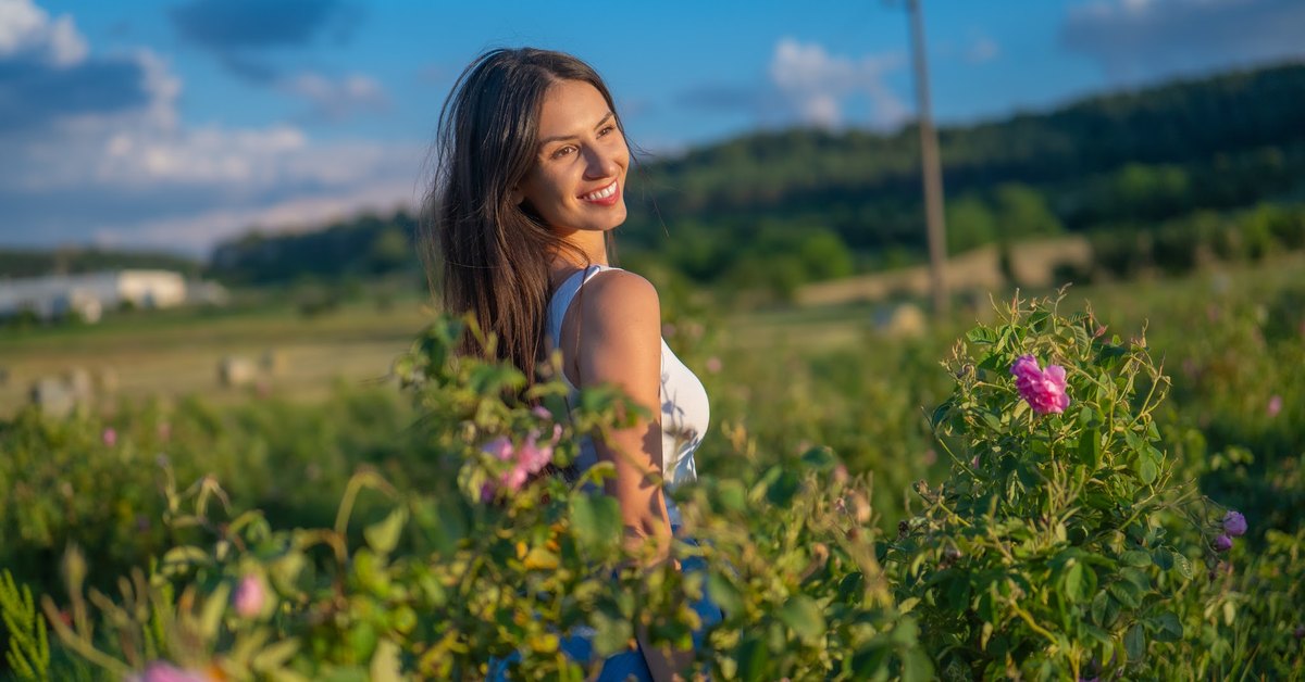 Woman in a blossoming rose field in the Bulgarian Rose Valley