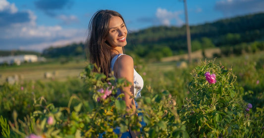 Woman in a blossoming rose field in the Bulgarian Rose Valley